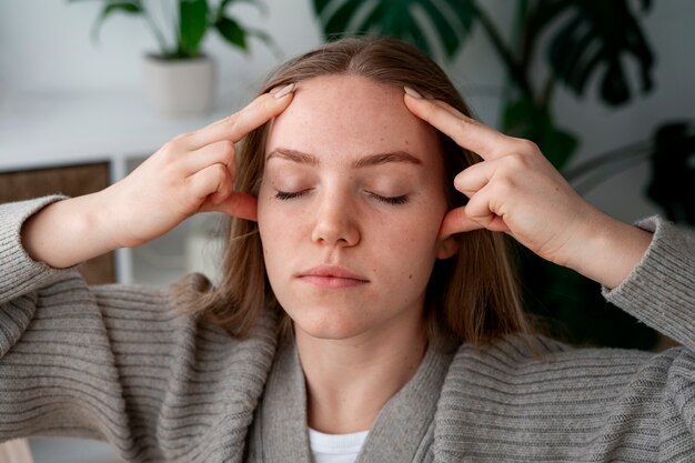 Woman giving herself scalp massage