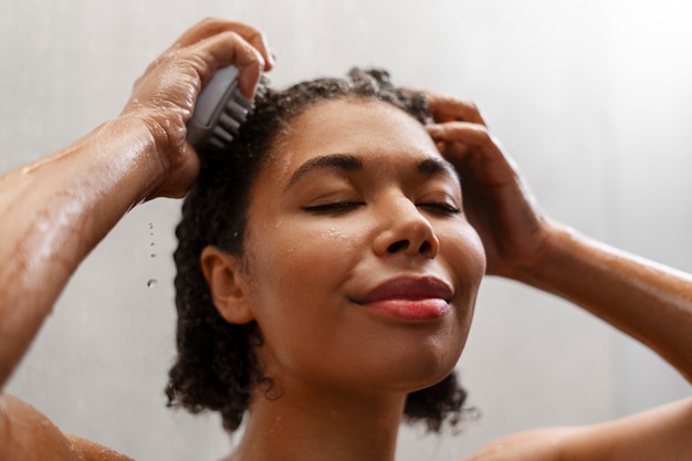 Free photo woman giving herself  scalp massage