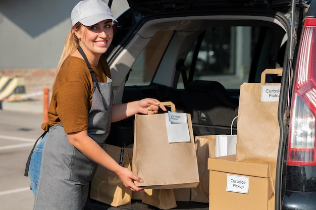 Woman giving an order at a curbside pickup outdoors