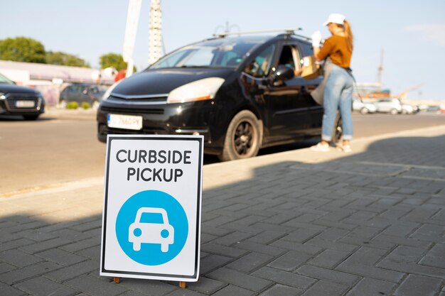 woman giving an order at a curbside pickup outdoors