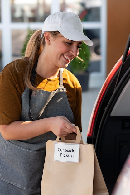 Woman giving an order at a curbside pickup