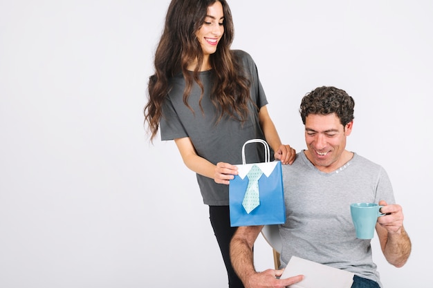 Free photo woman giving present to cheerful dad