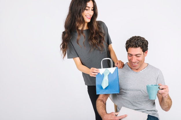 Woman giving present to cheerful dad