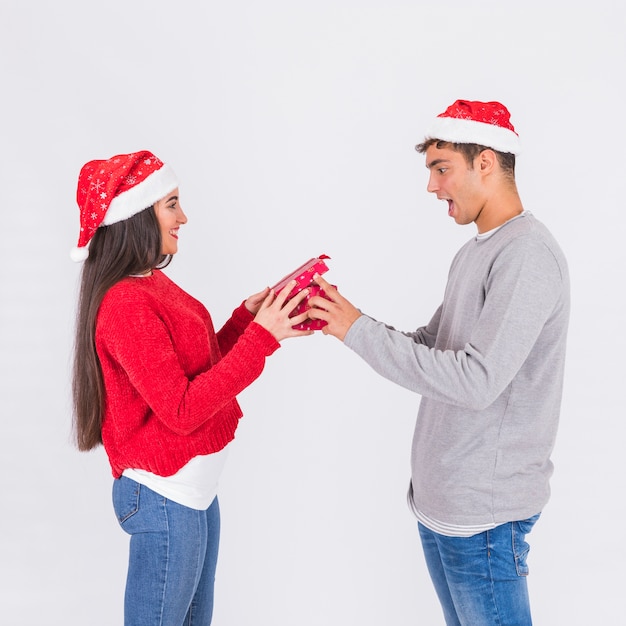 Woman giving present to excited boyfriend 