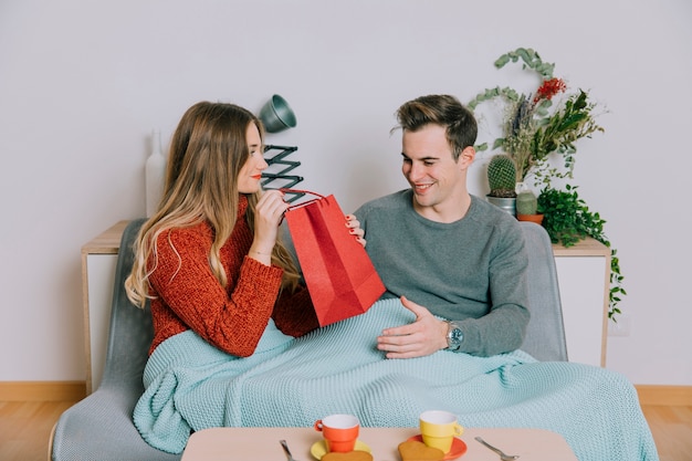 Woman giving present to man