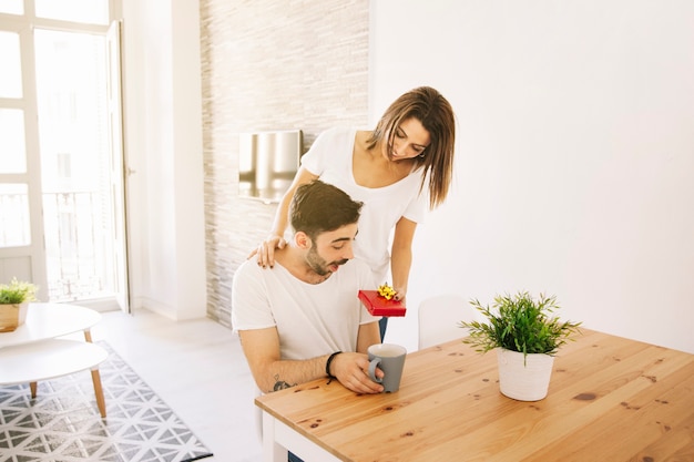 Woman giving present to man