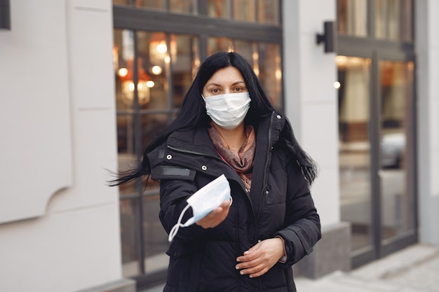 Free photo woman giving protective mask