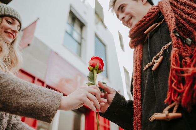 Free photo woman giving rose to man