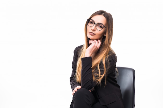 Woman in glasses sitting on a black chair on white