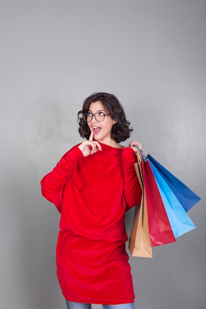 Free photo woman in glasses with shopping bags