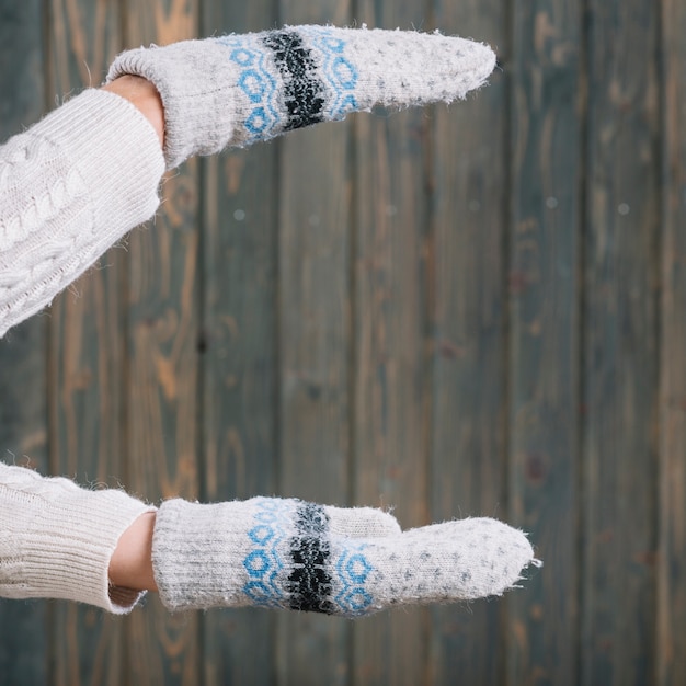 Free photo woman in gloves holding something in hands