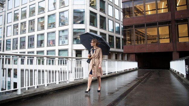 Woman going out in the city while it rains