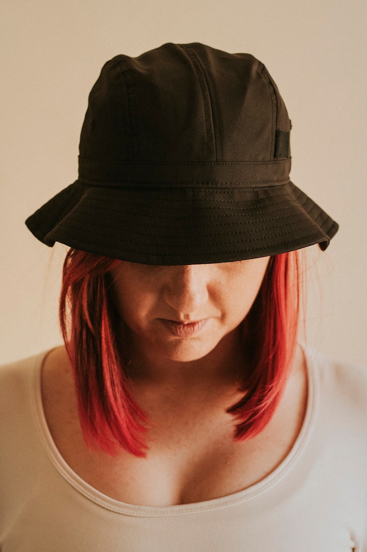Free Photo woman in a gray bucket hat apparel mockup