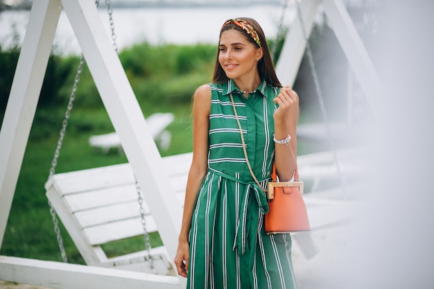 Woman in green dress in park