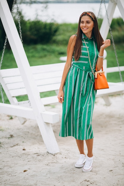 Free photo woman in green dress in park