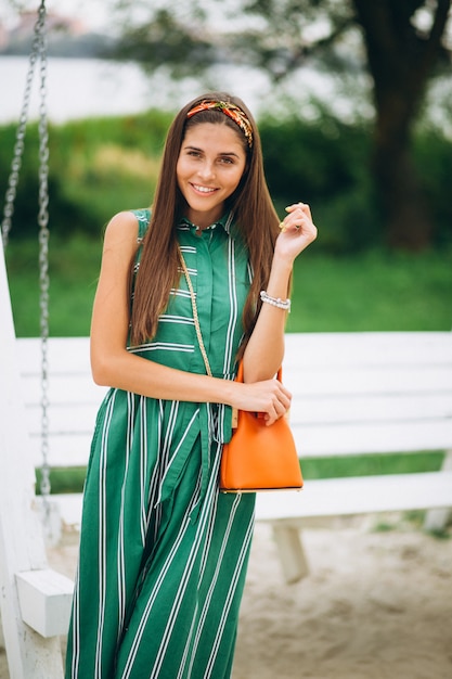 Free photo woman in green dress in park