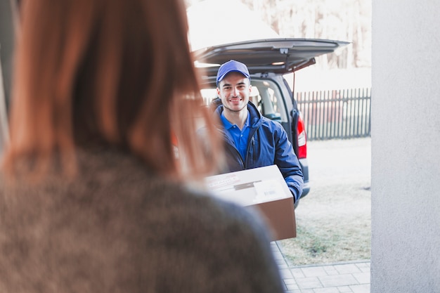 Woman greeting deliveryman on porch