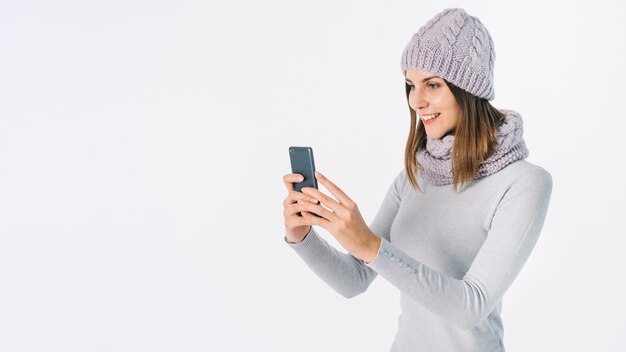 Woman in grey clothes taking selfie 