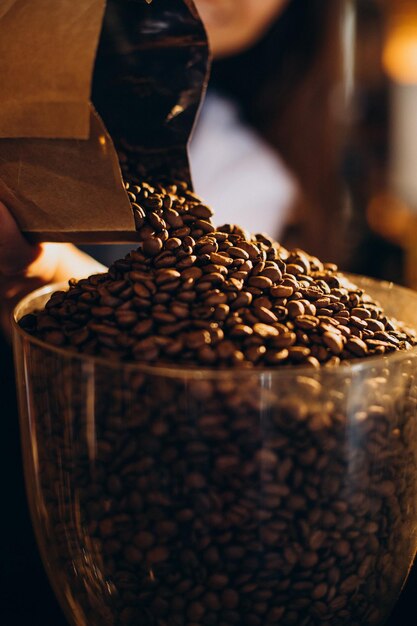 Woman grinding coffee in coffee machine