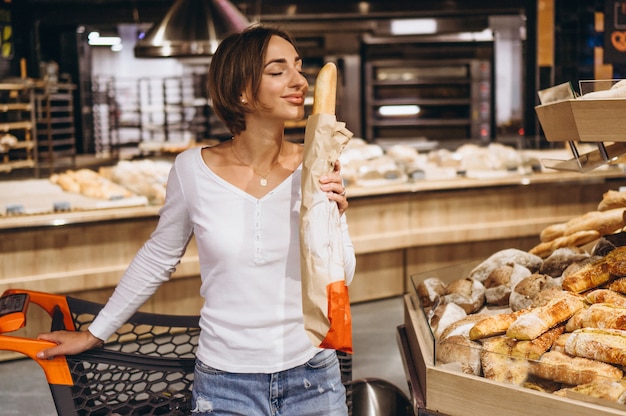 Free photo woman at the grocery store buying fresh bread