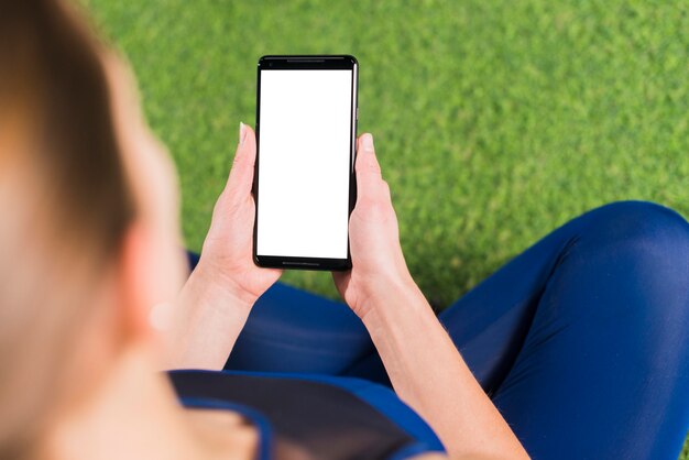 Woman in gym with smartphone template