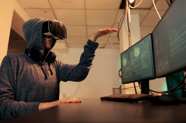 Woman hacking databse in metaverse, coding spyware in vr glasses, cracking server password, stealing electronic information. Cyberattack, internet criminal developing malware in virtual reality