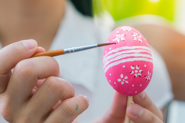 Woman hand  decorating Easter eggs