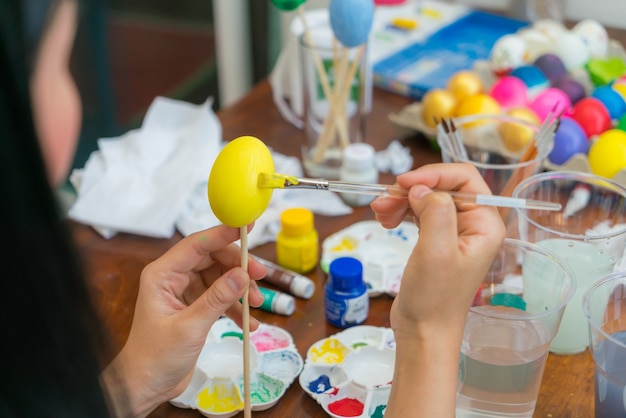 Woman hand  decorating Easter eggs