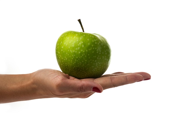 Woman hand holding apple on white.