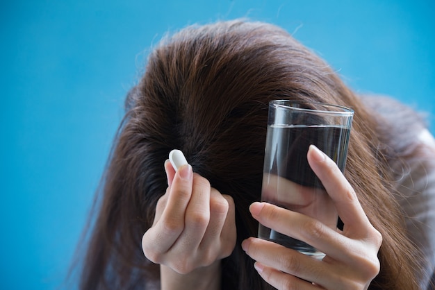 woman hand holding a pills take medicine according to the doctor's order