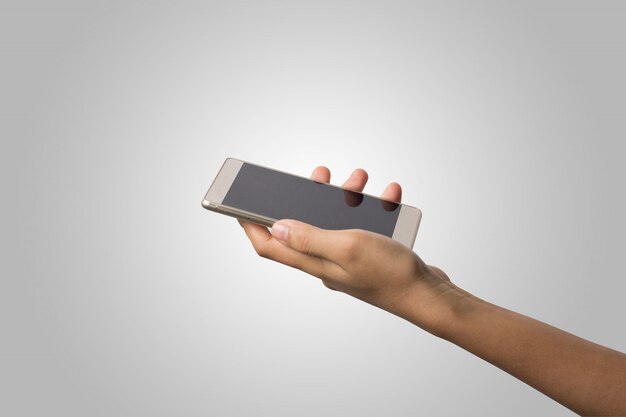 Женщина Рука держит смартфон пустой экран. Копирование пространства. Рука, проведение смартфон, изолированных на белом фоне.