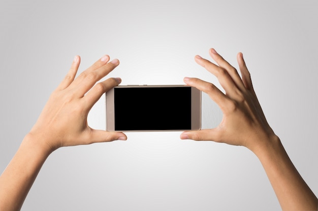 Woman Hand holding smart phone blank screen. Copy space. Hand holding smartphone isolated on white background.