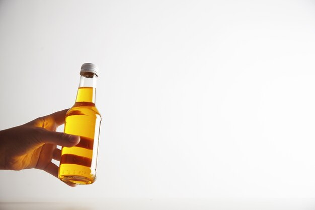 Woman hand offers cristal transparent bottle with refreshment drink inside