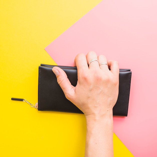 Woman hand with clutch bag