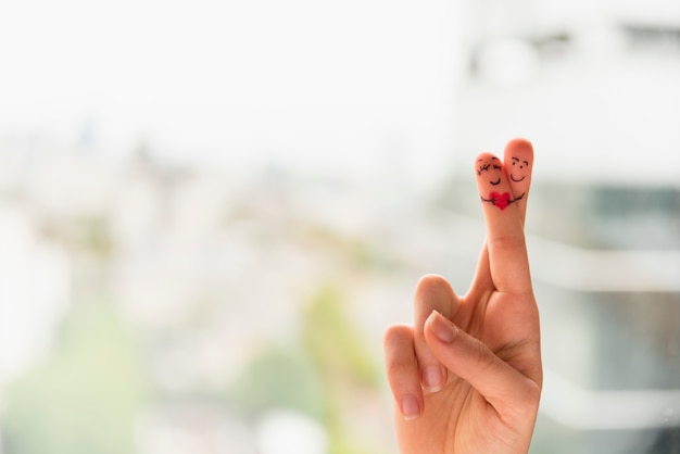 Woman hand with crossed painted fingers 