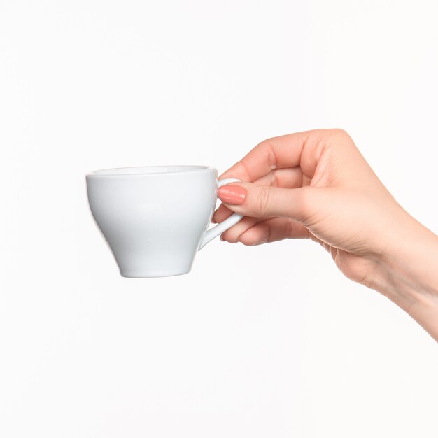 Woman hand with cup on white space