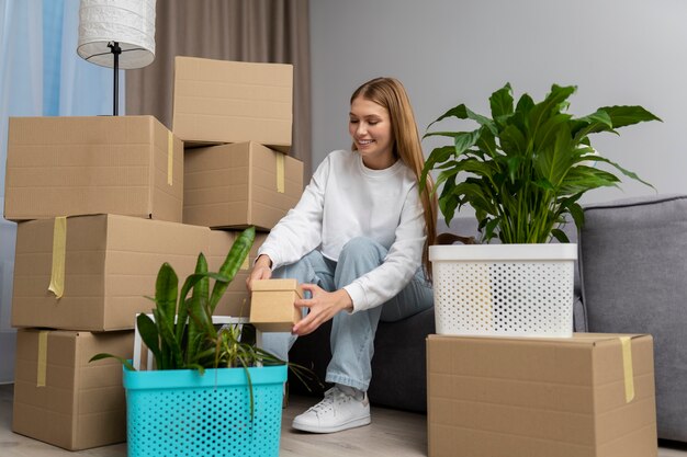 woman handling belongings after moving in a new house