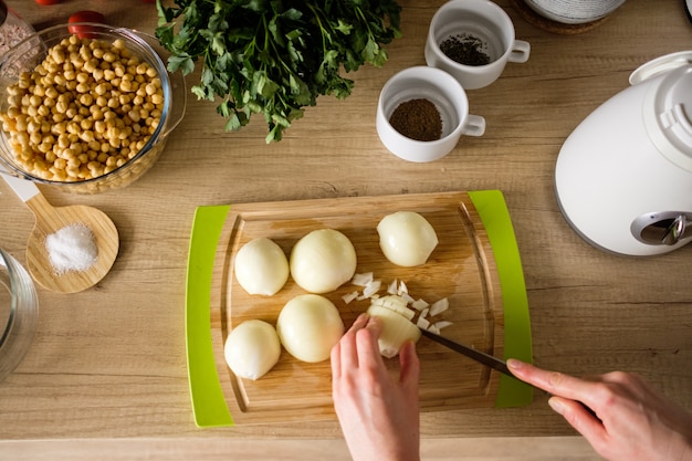 Woman hands, cutting onions