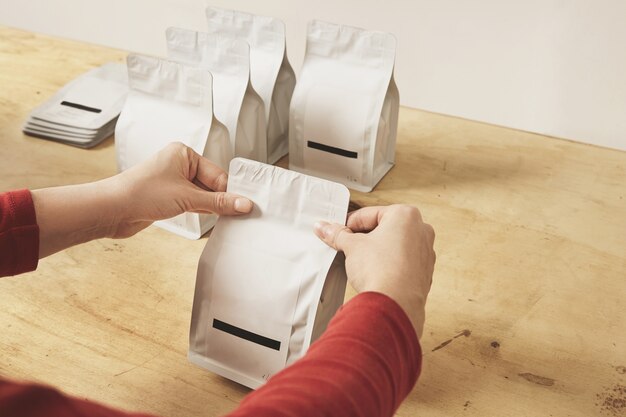 Woman hands getly seal blank bulk packages