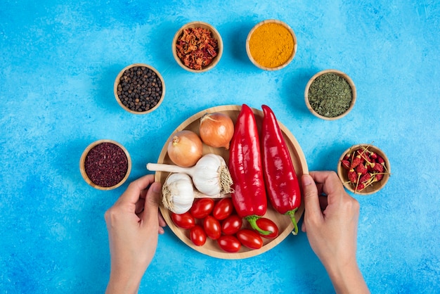 Woman hands holding plate of vegetables