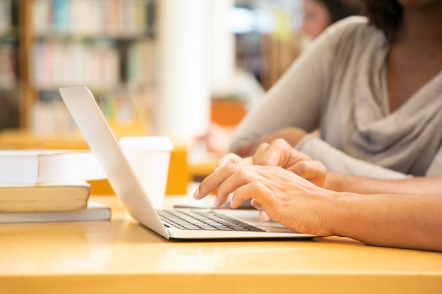 Woman hands typing on laptop