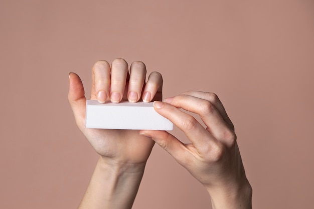 Woman hands with nail care product