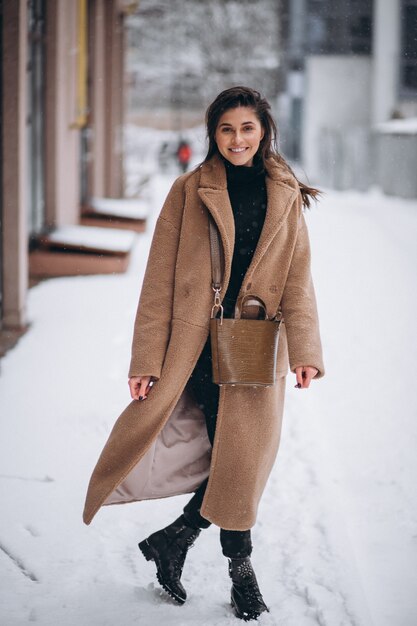 Woman happy in coat in winter outside