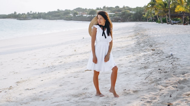 Woman in hat on the coast of the indian ocean