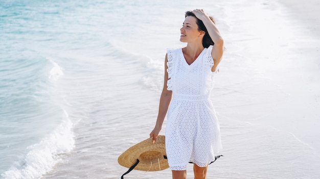 Woman in hat on the coast of the indian ocean