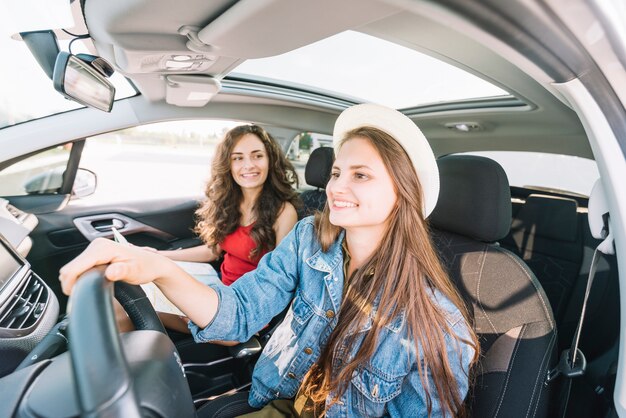 woman in hat driving car