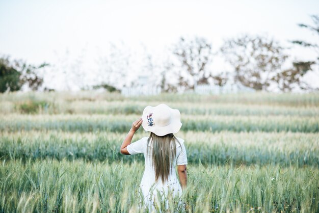 Woman in the hat happiness in the nature