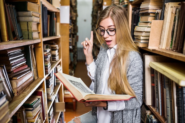 Woman have idea while reading book