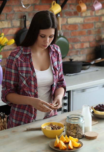 Woman having breakfast in the kitchen