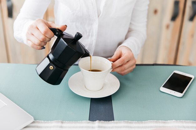 Woman having breakfast at the kitchen